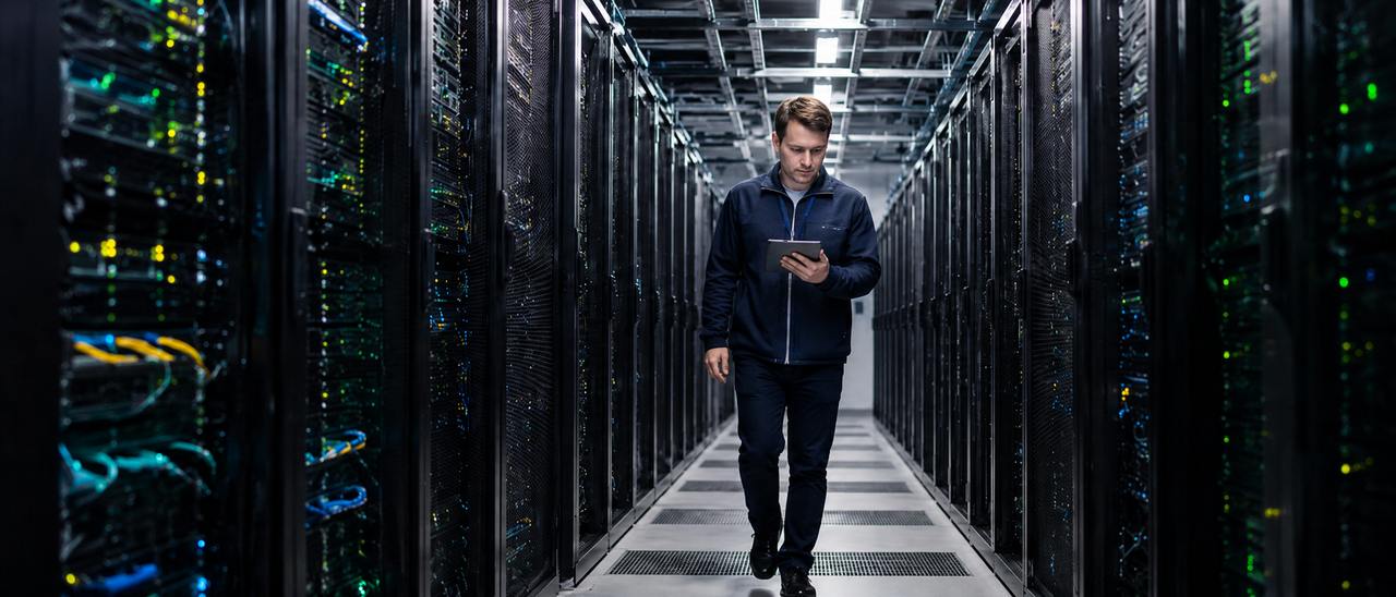 A technician walking through a data center
